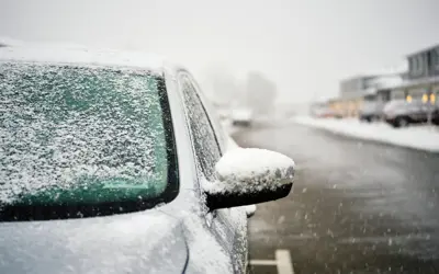 Car parked on side of road with snow