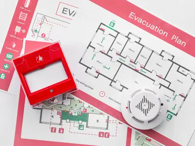 Fire alarm and smoke detector on top of evacuation plans